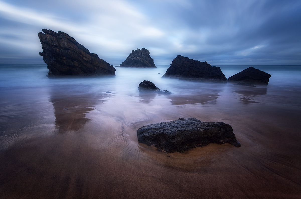 Rain, wind and the relentless tides are the elements that forged these characteristic rock formations at Praia da Adraga in an endless flow of time. With this long exposure I tried to capture this sense of fortitude. 