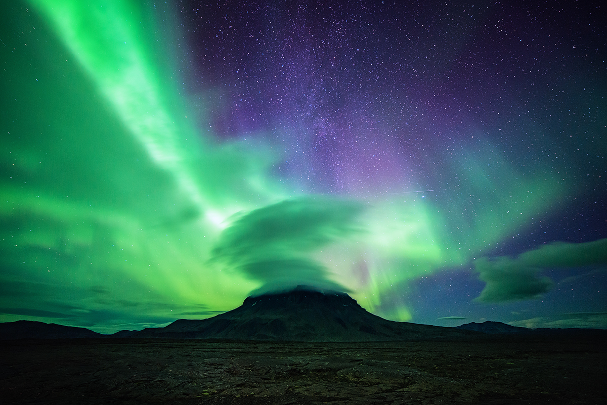 Iceland's highest tuya "Herðubreið" steadfast under the northern lights, milkyway and a hat made of lenticular clouds. It is the highest elevation in the ash-desert of Ódáðahraun, towering with more than 1600m over the highlands which average around 700 meters. 